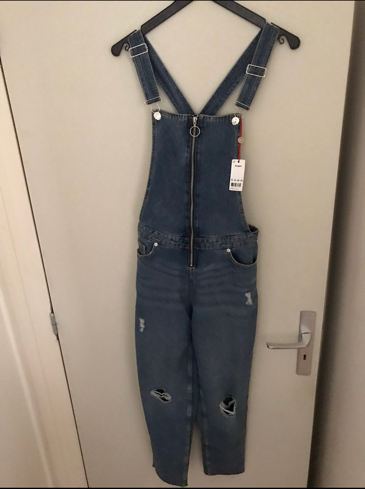 Blue denim overalls with adjustable crossed straps for women