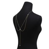 Long golden women's necklace with crystal pendant for back